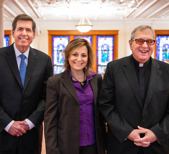 Woman sits holding a pencil. 